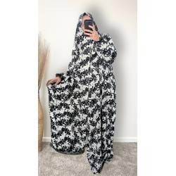 Perfect Gift  One Size Only (52" - 64") fits UK sizes 8 to 24.  62-64”/160cm- Standard Length: The dress is designed to be long enough to cover your feet while praying Salah. If you would like to adjust the length, please click on the 'Tailored Length' option and specify your preferred length in the 'Order Notes' section at checkout, or email us, and we will confirm the change via email. You can refer to the size chart below to help you determine the suitable length  83cm - Width of dress : This refers to one side of the dress when laid flat, making the full circumference approximately 166cm. The dress is intentionally designed to be wide and oversized for a modest, full-coverage fit.  75cm - Sleeve length (from wrist to shoulder) Hijab Measurements: 210 cm (Length) x 60 cm (Width) Optional: You can choose to have the hijab attached or separate from the abaya Attached Hijab: The hijab will be attached with the short side on the right allowing the long side to be wrapped with your left hand.&nbsp; If you prefer a right - handed wrapping arrangement, please add a note in the 'Order notes' section at checkout, or email us, and we will confirm the change via email. You must notify me within 24 hours before I proceed with sewing the custom attachment. Invisible side pockets Elastic cuff finished Lace finish on the cuff and hijab&nbsp; Material - Polyester&nbsp; Colour - Black & White