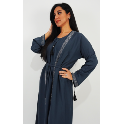 Perfect Gift Elegant Blue Open Abayaintricate silver embellishmentsFabric: Zoom and Korean nidalength: 170cm Elevate your modest fashion with this sophisticated Blue Open Abaya, featuring a graceful silhouette with silver embellishments along the neckline and cuffs. The contrast white cuff detailing adds a touch of elegance, while the tassel accents bring a chic, modern vibe. Designed for versatility and comfort, this abaya comes with a matching waist belt, allowing you to wear it open for a layered look or cinched for a structured fit. Crafted from premium lightweight fabric, it drapes beautifully, ideal for everyday elegance or special occasions. Whether dressing up or keeping it casual, this abaya is the perfect blend of luxury and sophistication. Size chart: Chest : Measure under your arms, around the fullest part of the your chest.Waist : Measure around your natural waistline, keeping the tape a bit loose.Hips : Measure around the fullest part of your body at the top of your leg. SIZENUMERIC SIZELENGTHS54160-170M56160-170L58160-170